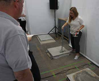 Ann Harrer, WJE, demonstrates NDT methods on concrete samples